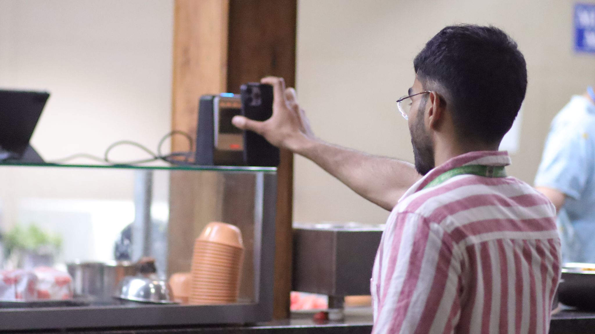 Students using CutTheQ app in canteen